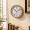 A simple wall-mounted clock with a golden frame for the living room and bedroom, featuring silent hands details Picture